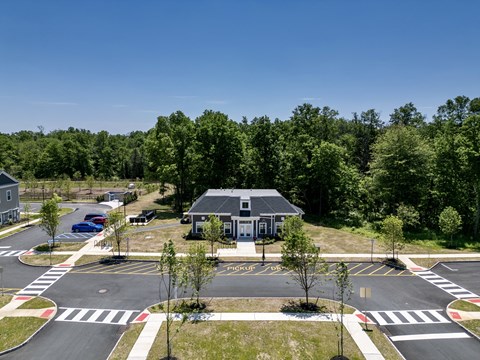 an overhead view of a parking lot and a house in a parking