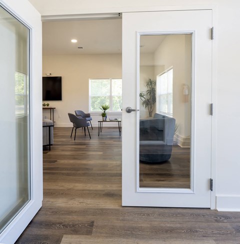 a view through a door into a living room with a couch and a table