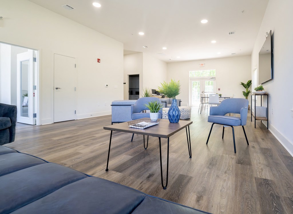 a living room with blue couches and a coffee table