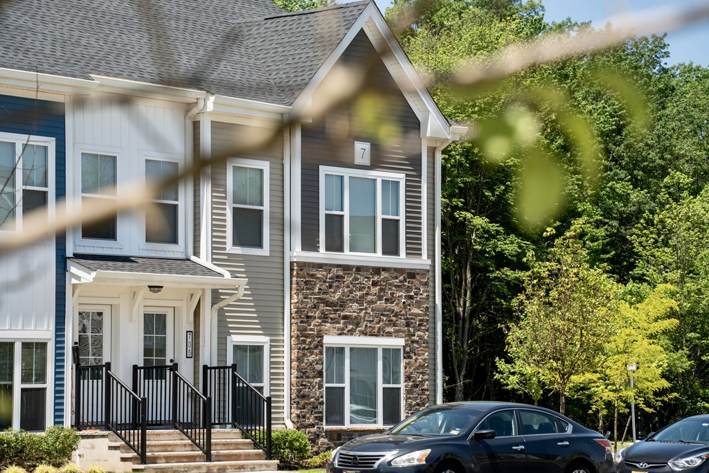 the exterior of a house with cars parked in front of it