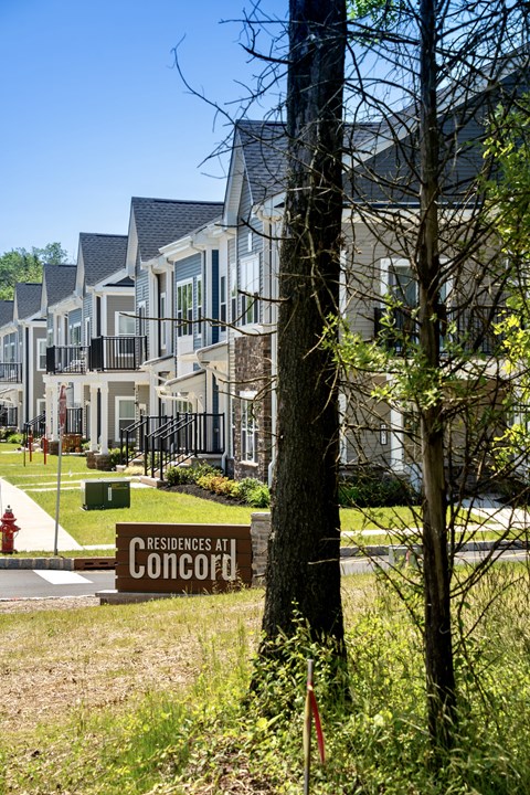 a sign in front of a row of houses