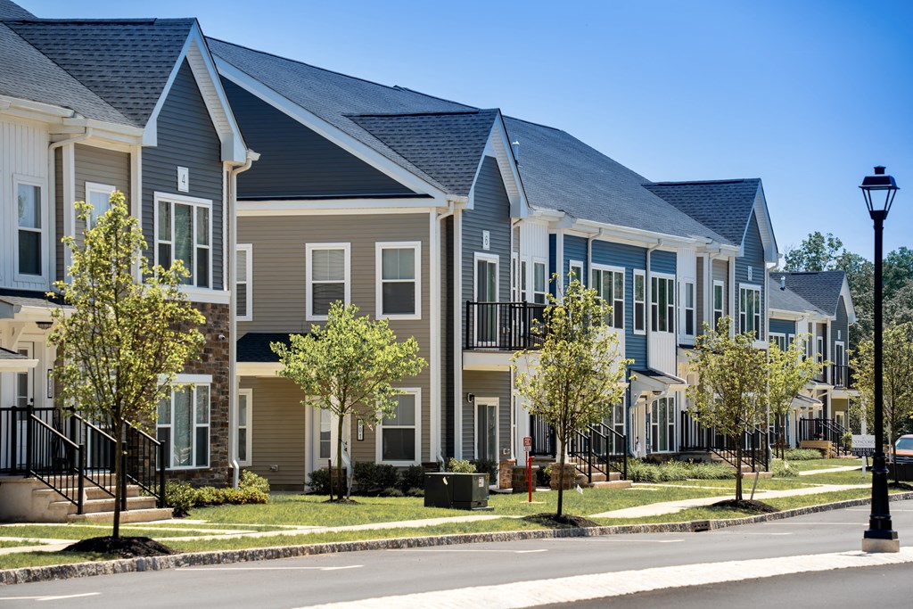 a row of town houses on the side of a street