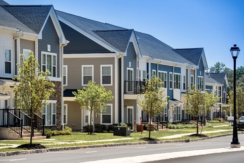 a row of town houses on the side of a street