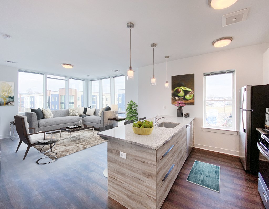a living room with a kitchen and a couch and a table