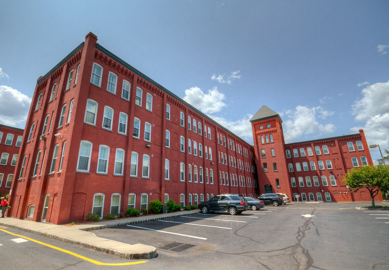a large red building with cars parked in front of it