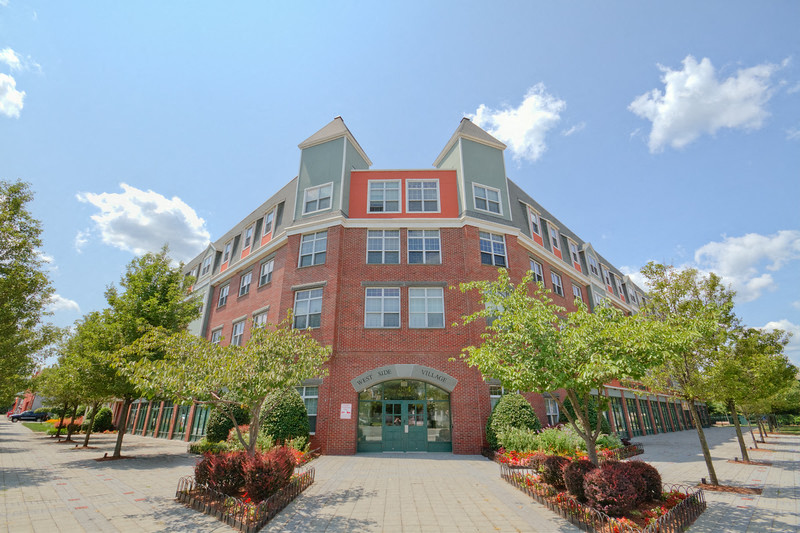a large brick building with trees in front of it