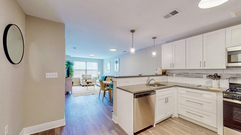 A kitchen with white cabinets and a wooden island.