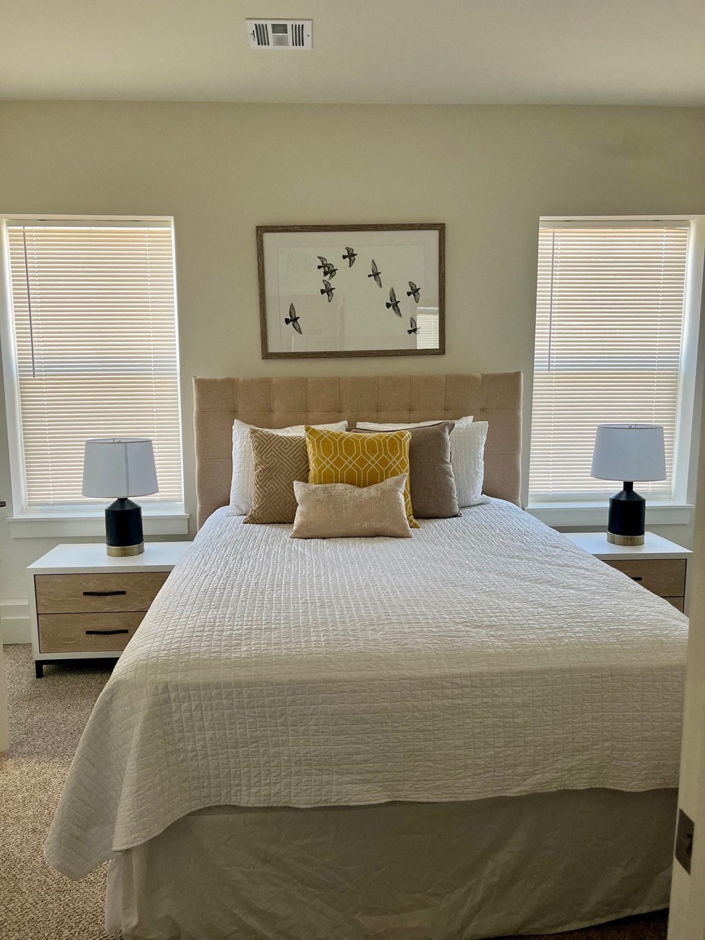 a bedroom with a bed and two nightstands with lamps