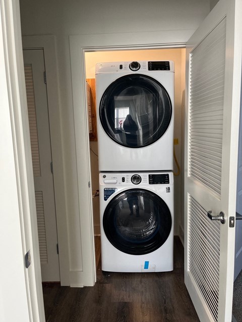 a white washer and dryer in a small room