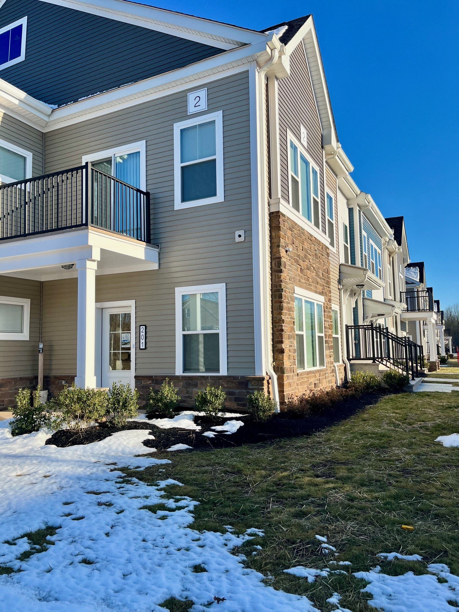an apartment building with snow on the ground