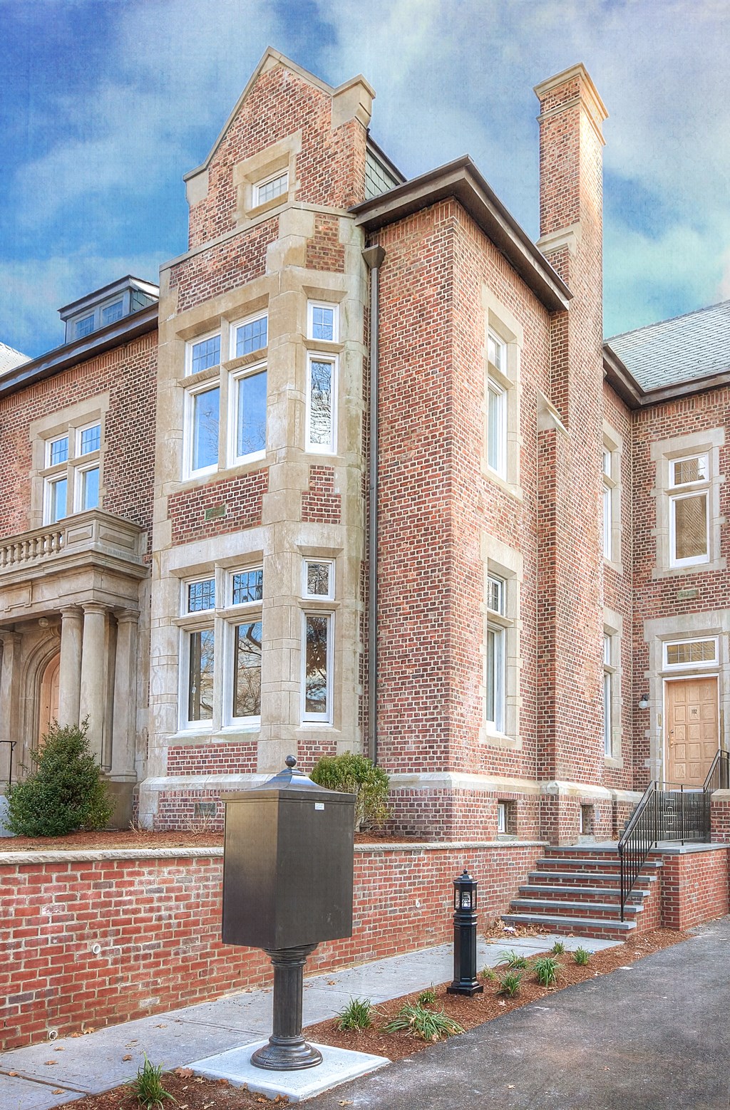 a large brick building with a mailbox in front of it