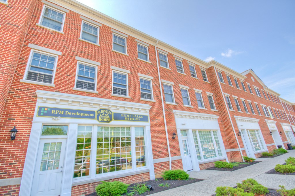 the front of a brick building with a sign in the window