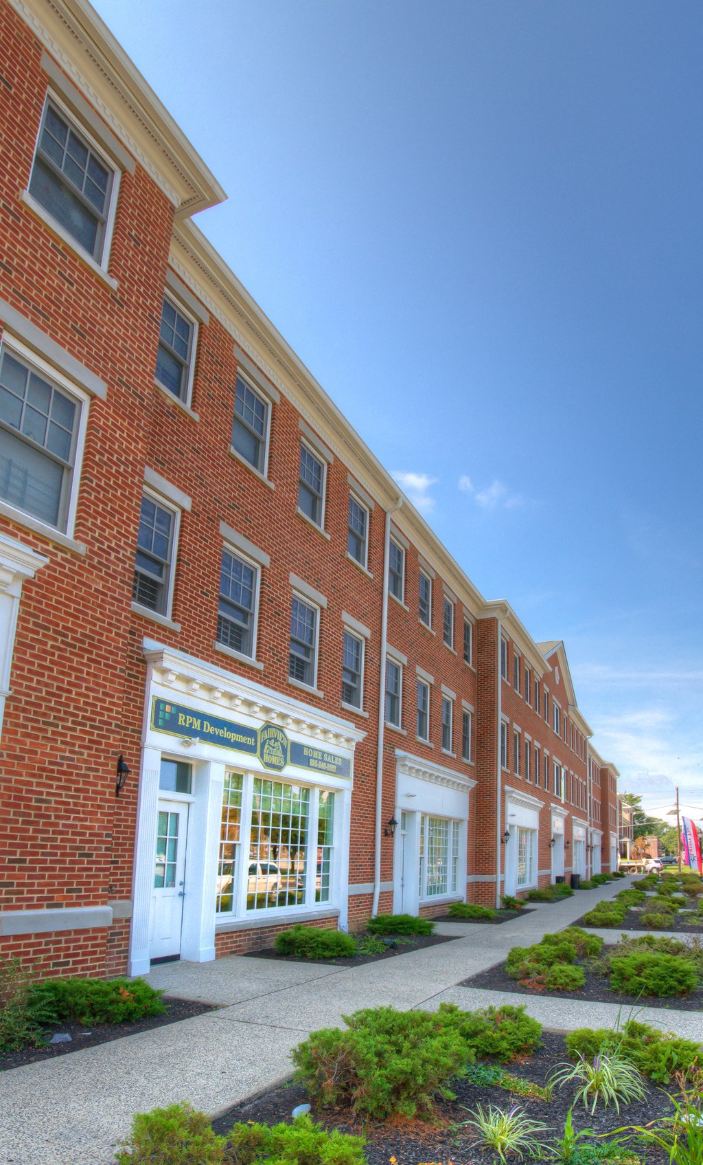 a large brick building with a sidewalk in front of it