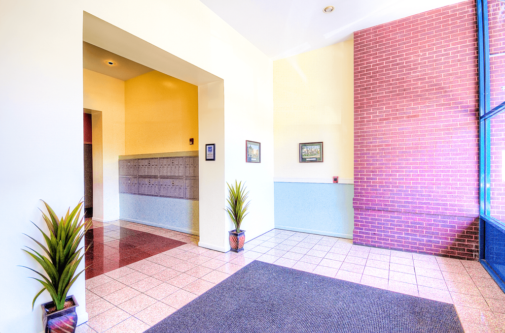 a lobby with a red brick wall and a blue and white wall with a door