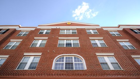 a red brick building with windows and a blue sky