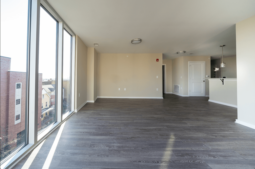 an empty living room with a large window