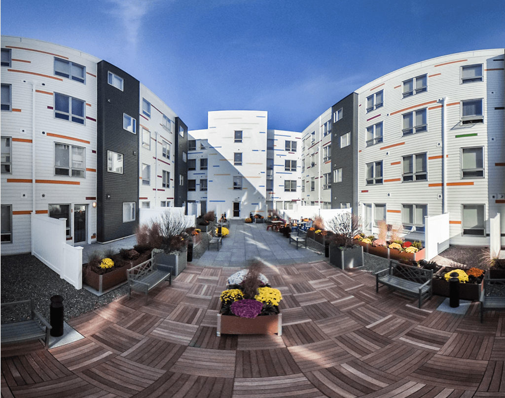 a rendering of an apartment complex with a courtyard