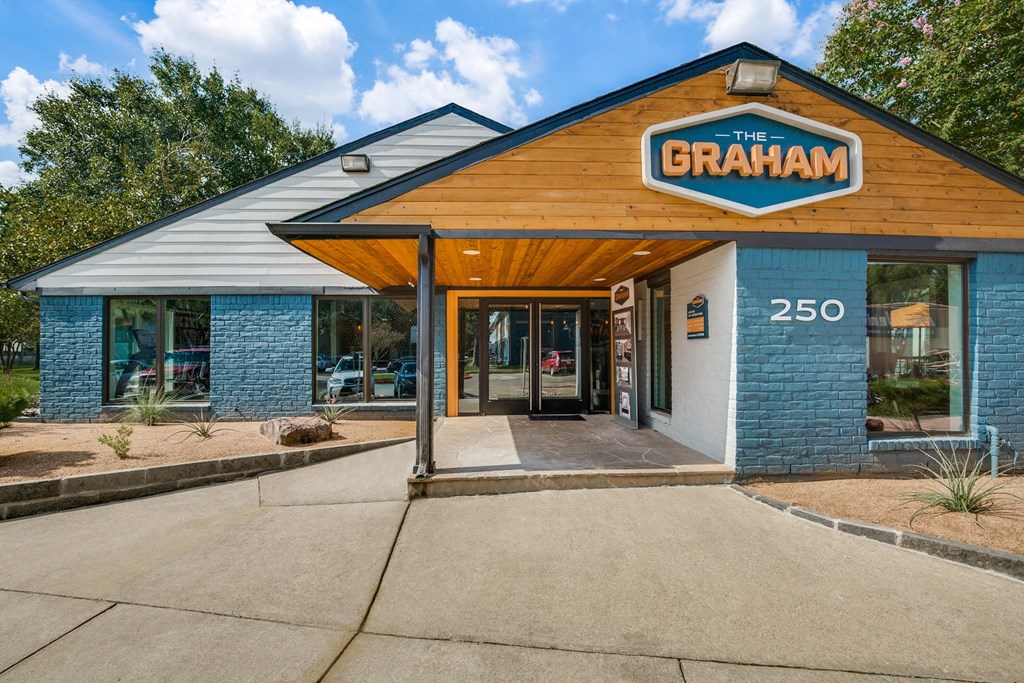 the restaurant exterior with blue brick building and wood roof