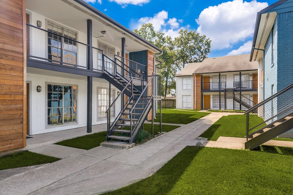 an apartment building with a staircase in front of it