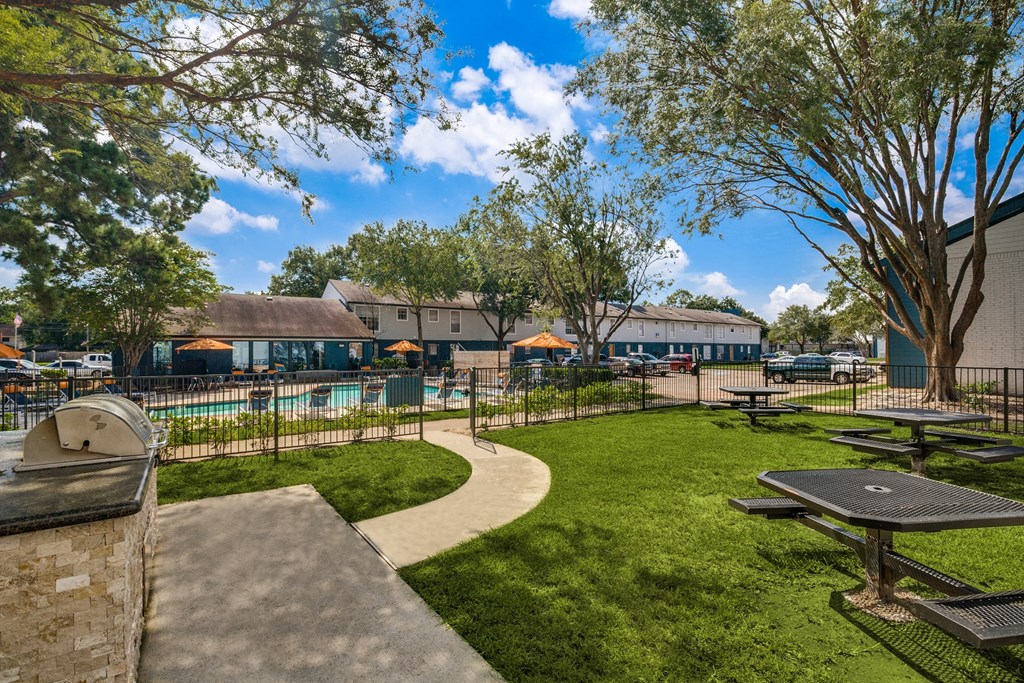 a park with picnic tables and a swimming pool