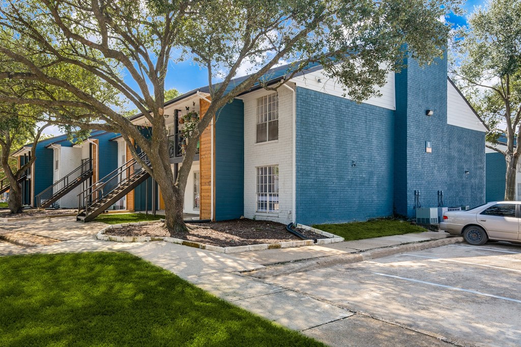 a blue and white building with a tree in front of it
