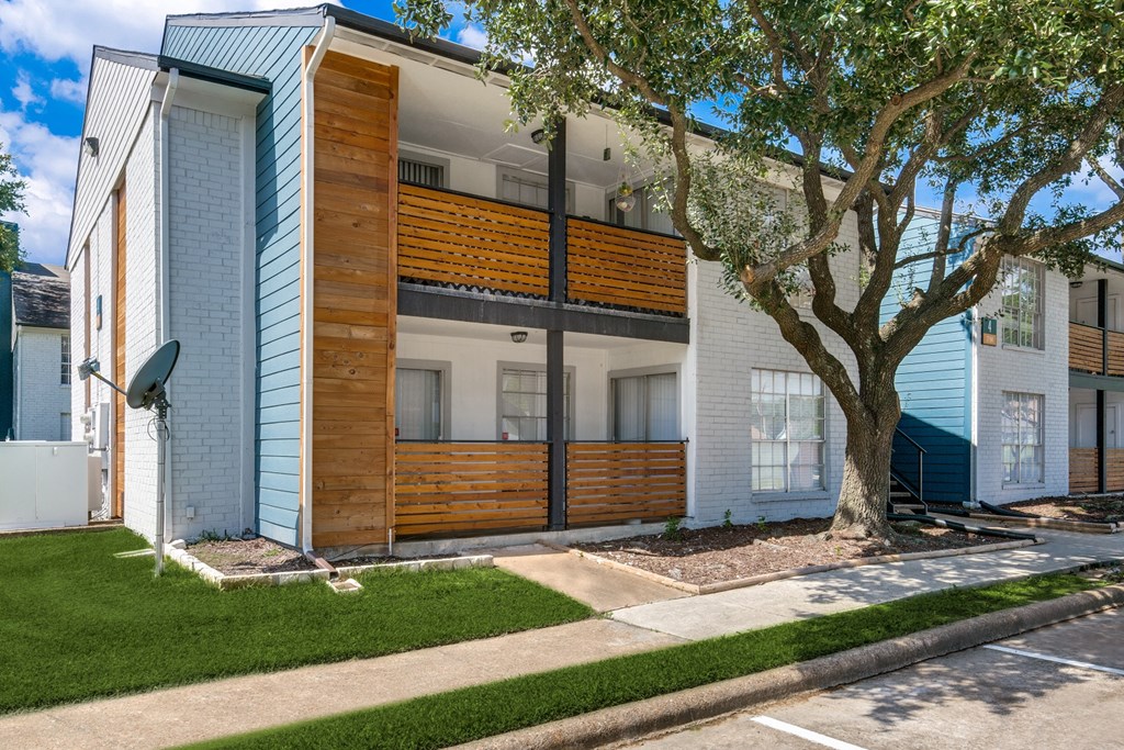 the exterior of a house with a tree in front of it