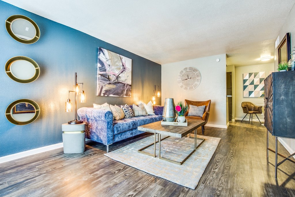 a living room with blue walls and a couch and a table