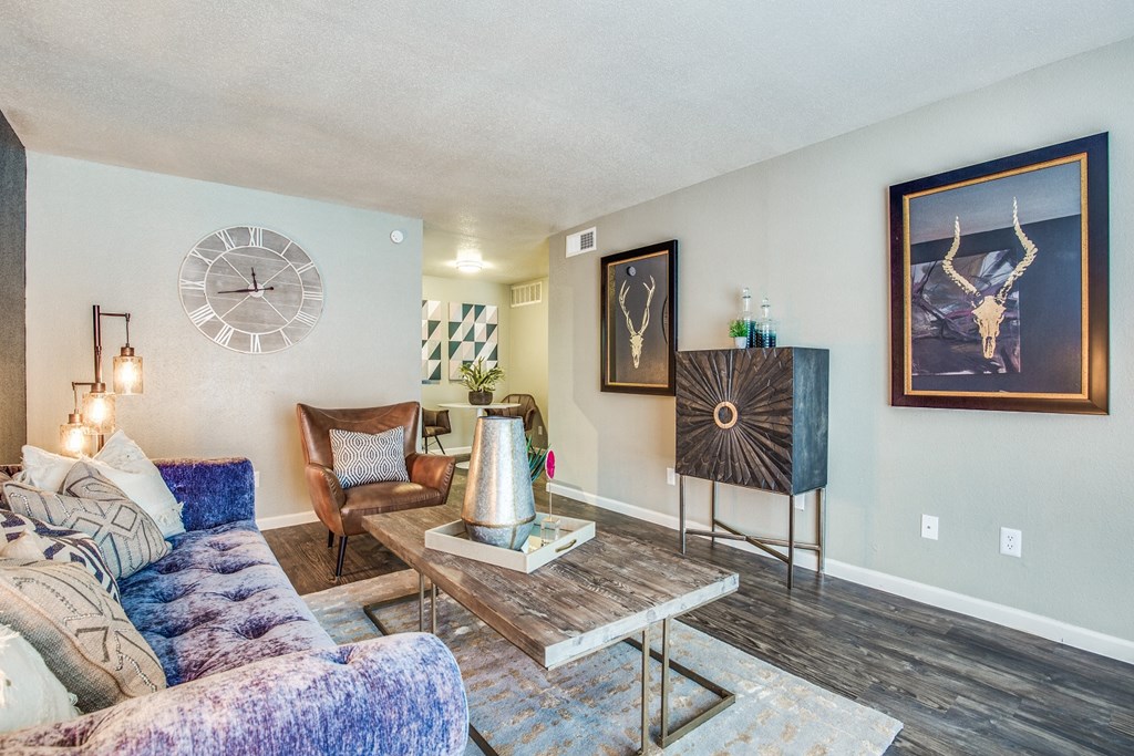 a living room with a couch and a clock on the wall