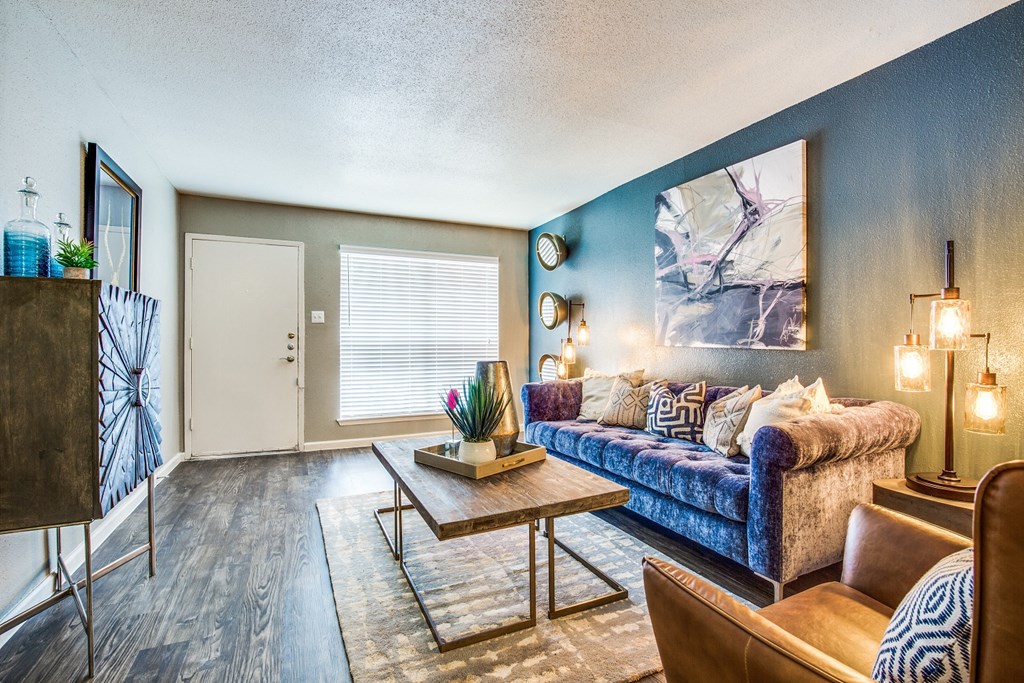 a living room with blue walls and a couch and a coffee table