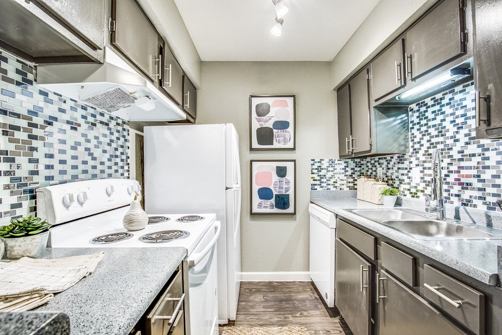 a kitchen with stainless steel appliances and a white refrigerator