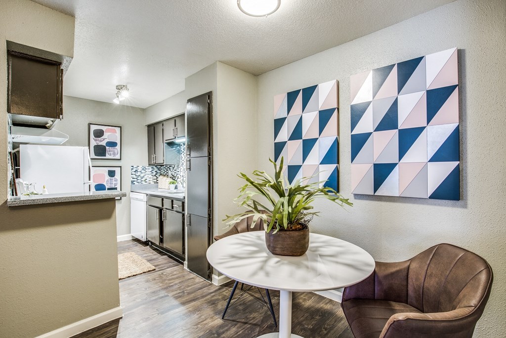 our apartments have a kitchen and living room with a table and chairs