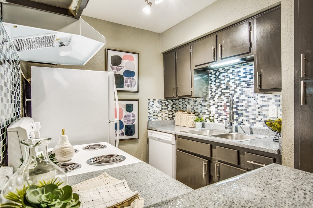 a kitchen with a stove sink and refrigerator