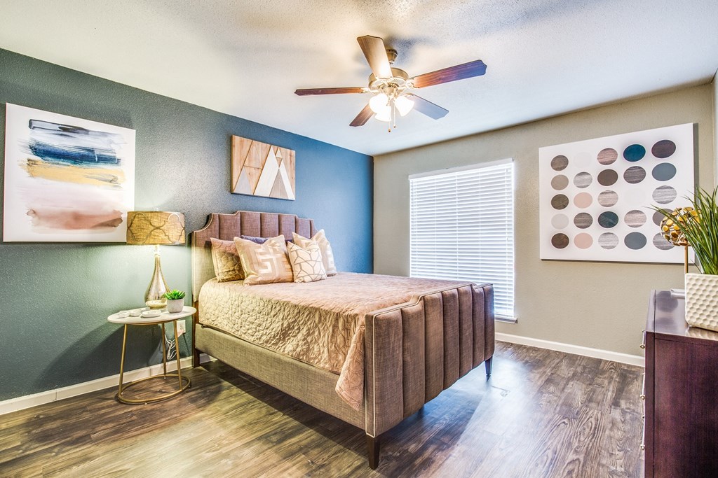 a bedroom with a bed and a ceiling fan