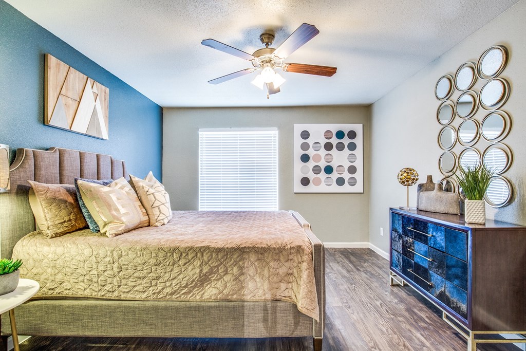 a bedroom with a large bed and a ceiling fan