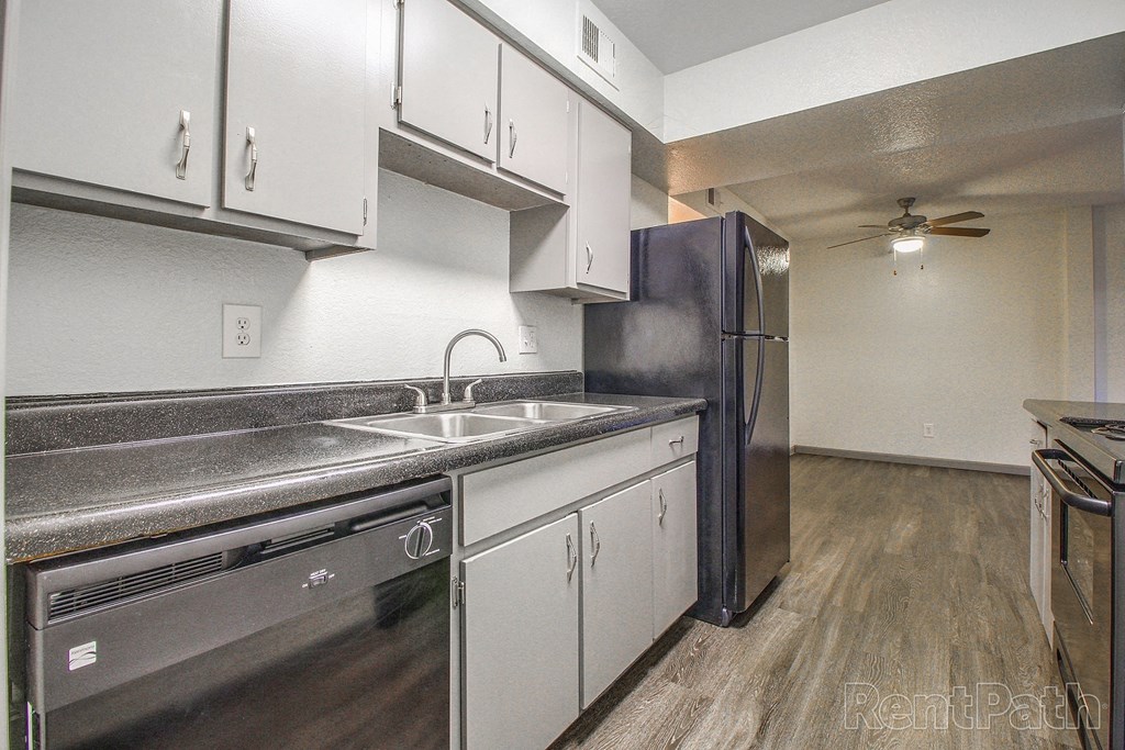 a kitchen with stainless steel appliances and white cabinets