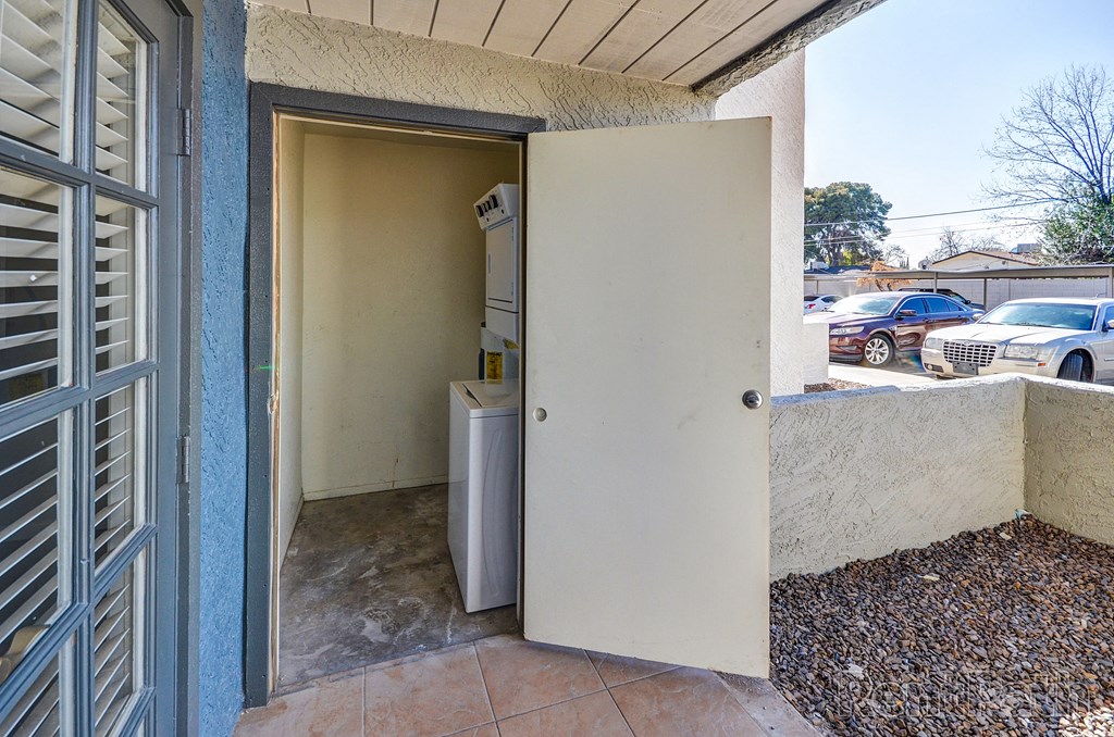 the entrance to an apartment building with an open door and a refrigerator