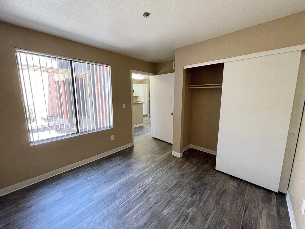 a bedroom with a closet and a large window