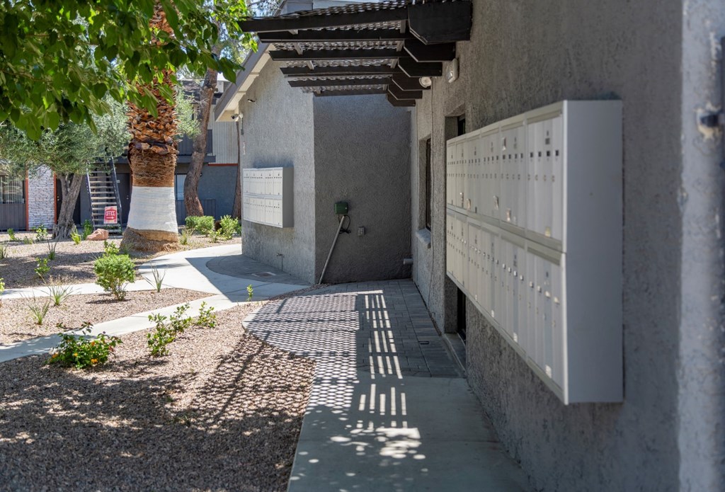 the front of a building with a white gate