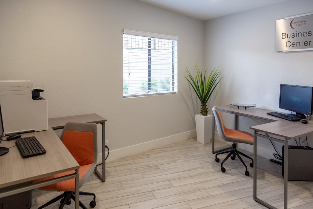 a business center with two desks and a computer