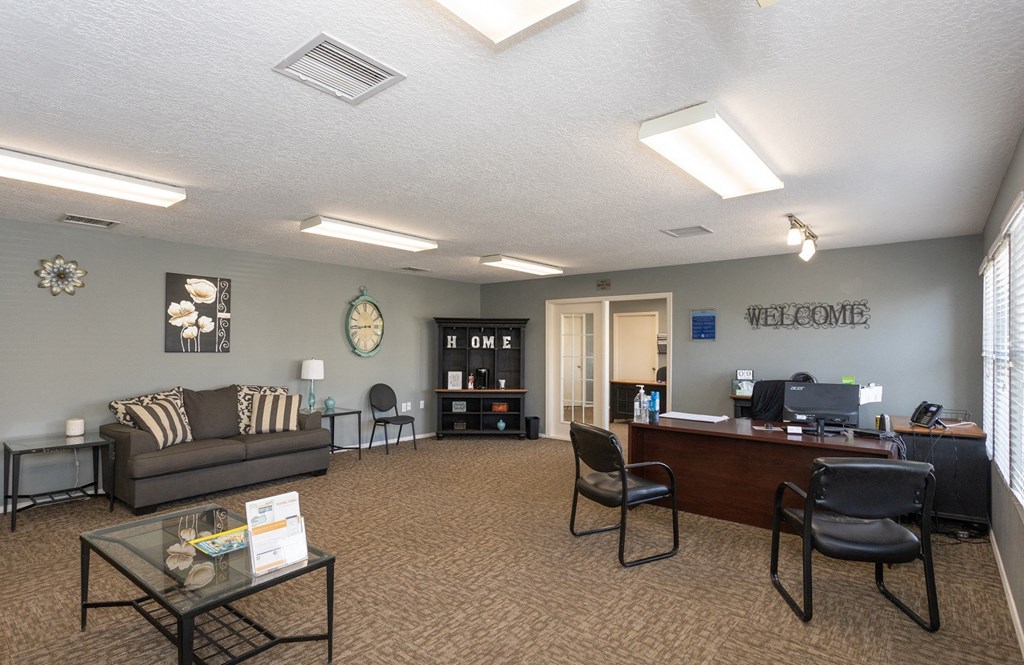 a lobby with couches and chairs and a reception desk