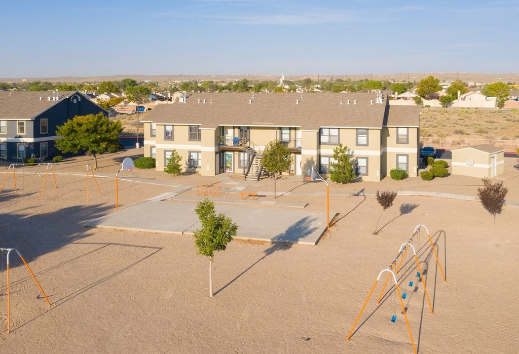 an aerial view of a playground in front of an apartment building