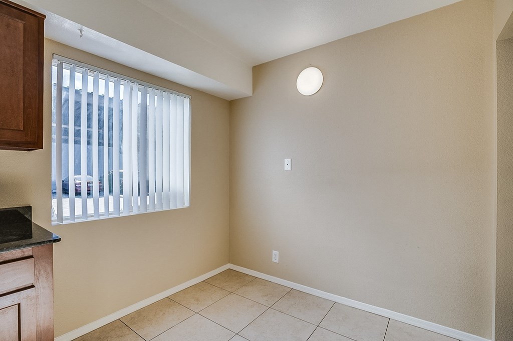 the living room and dining room of an empty home with a window
