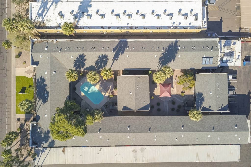 a birds eye view of a house with a pool and palm trees