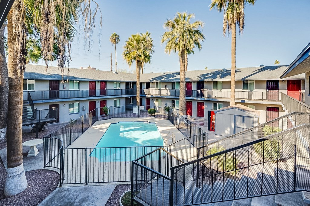 our apartments have a swimming pool and a courtyard with palm trees