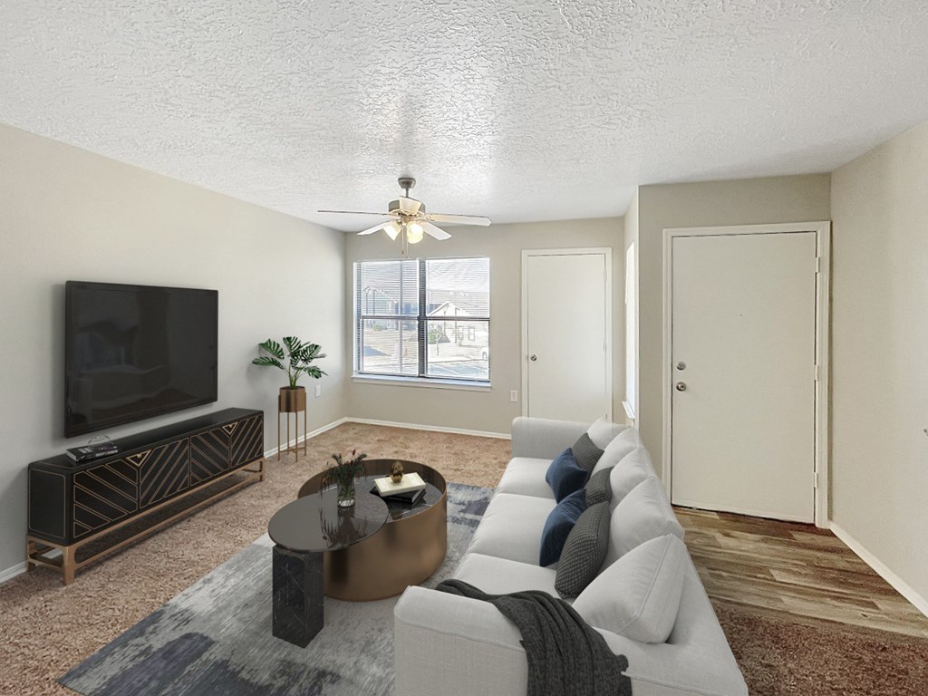 an empty living room with a couch and a tv