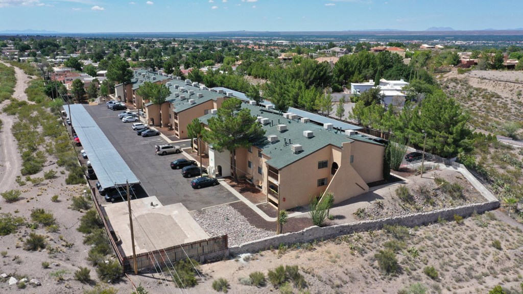 a group of houses with green roofs and a parking lot