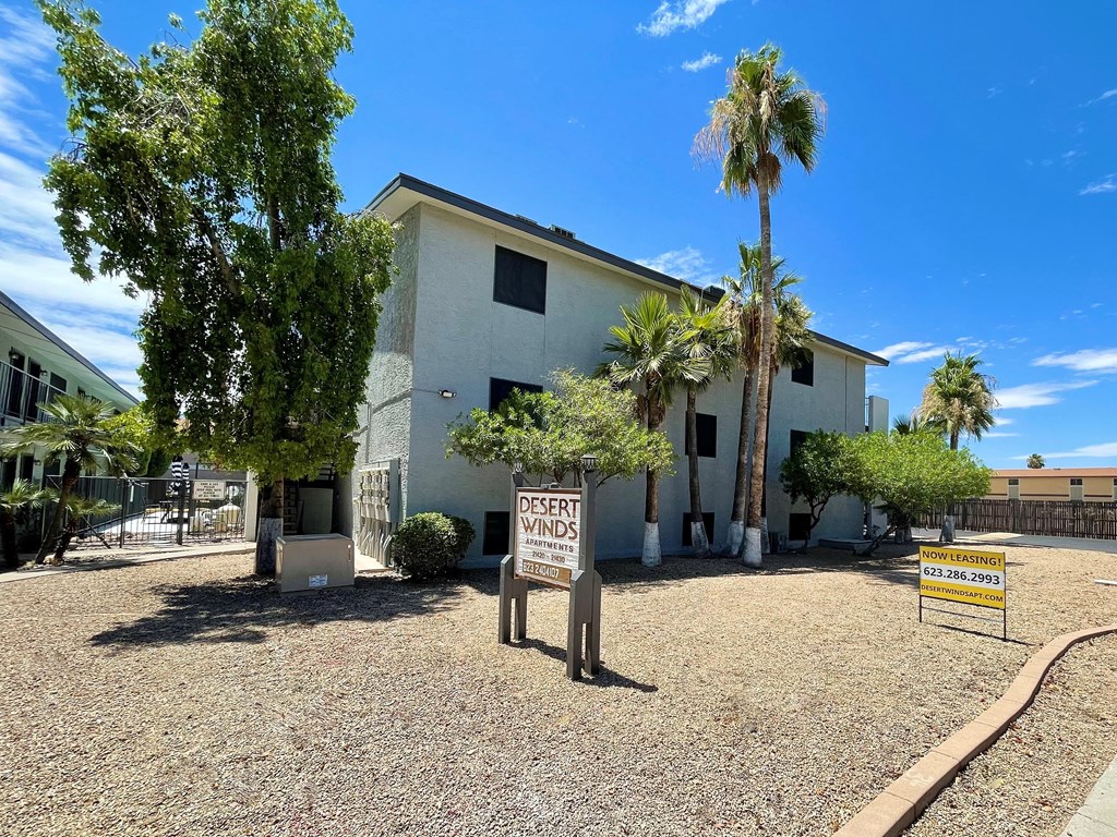 a white building with palm trees in front of it