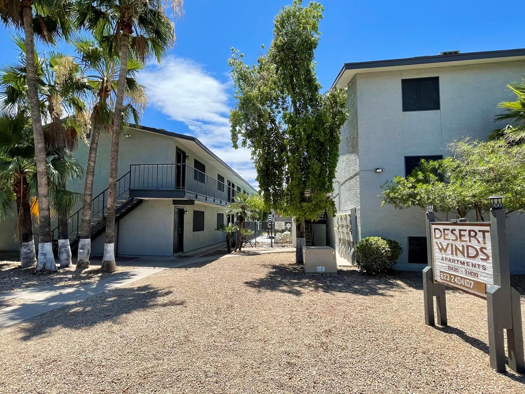 a building with a desert winds sign in front of it