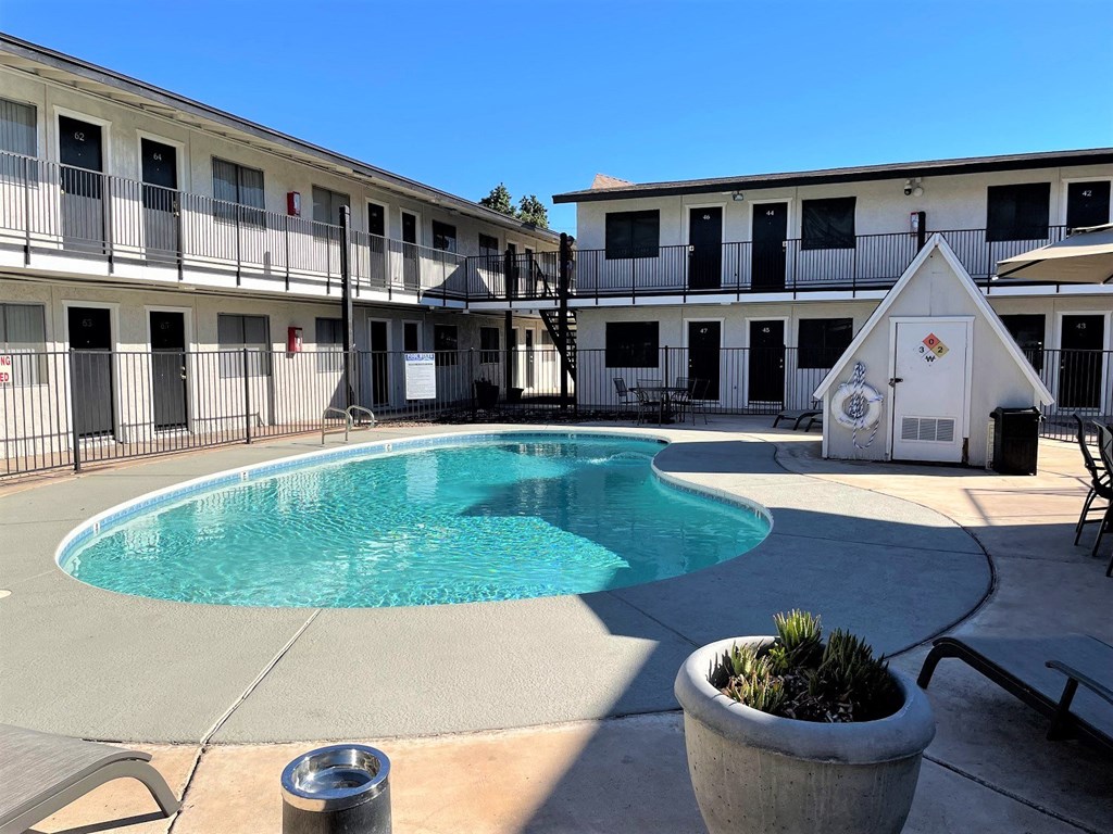 the pool is in the courtyard of a motel