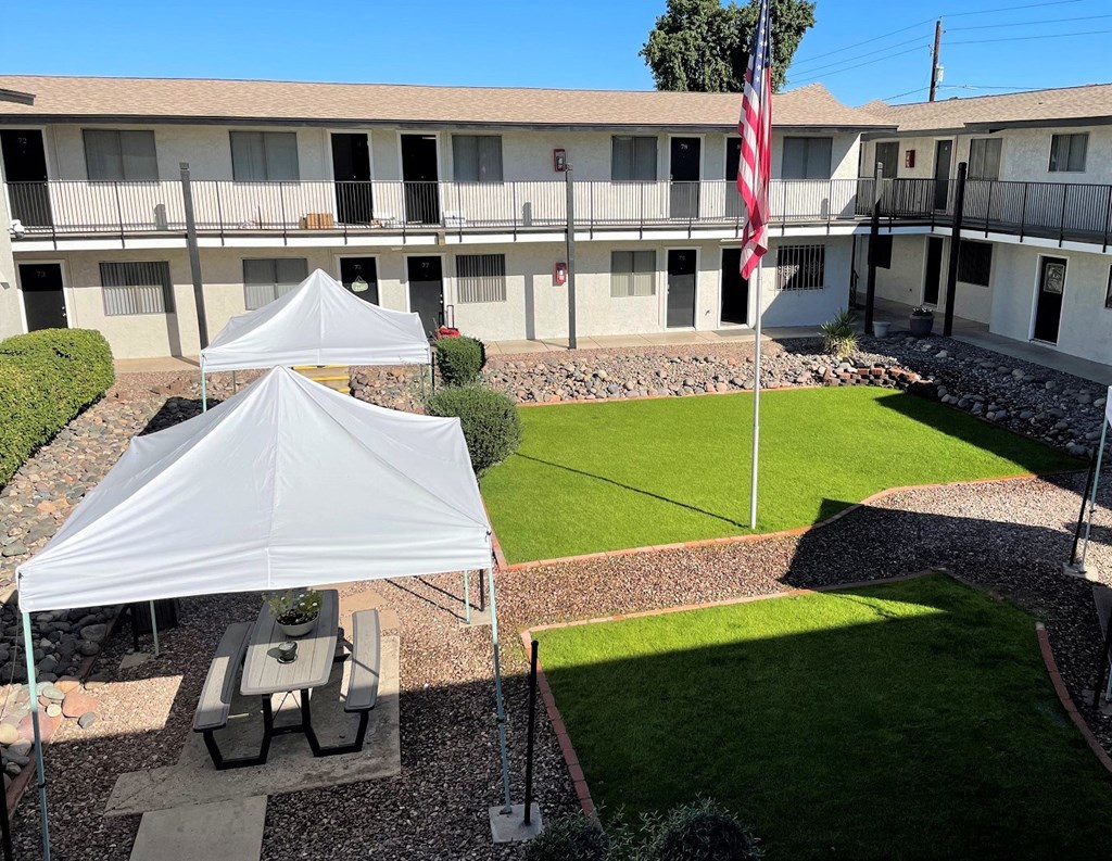 a tent is set up in a yard in front of a building